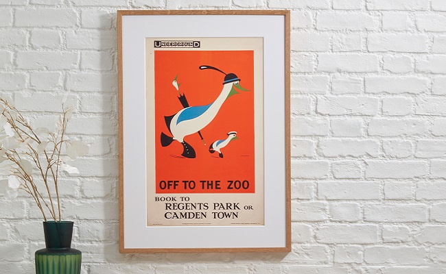 Zoo poster framed in pale wooden frame on white brick wall